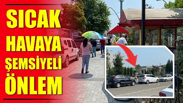 Şemsiye ile sıcaktan korundular
