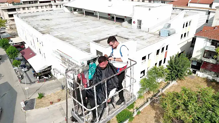 15 yıllık berber yeni açtığı dükkanının ilk tıraşını gökyüzünde yaptı