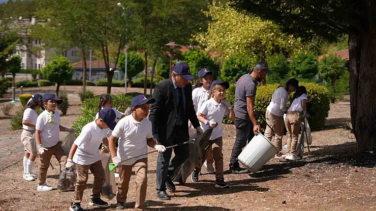 Parkı temizleyen görevlilere öğrenciler destek oldu
